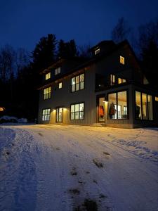 a large house in the snow at night at The Carriage House at Boulder Mountain View in Carroll
