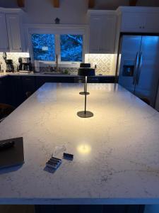 a kitchen with a white counter top with a table at The Carriage House at Boulder Mountain View in Carroll