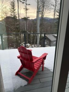 a red chair sitting on a porch in the snow at The Carriage House at Boulder Mountain View in Carroll +42 photos