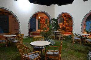 a patio with tables and chairs in a yard at Hllol Hotel Abu Simbel in Abu Simbel