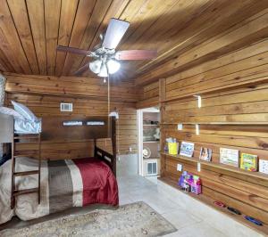 a log cabin bedroom with a bed and a ceiling fan at Charming Atlanta Home in Atlanta