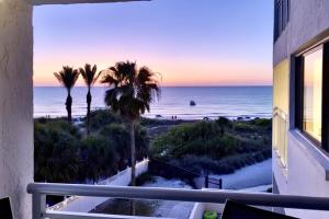 a view of the beach from a balcony at Siesta Sands Beach Resort 4th Floor with Elevator in Sarasota