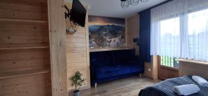 a bedroom with a bed in a wooden room at Przy Potocku in Czarna Góra