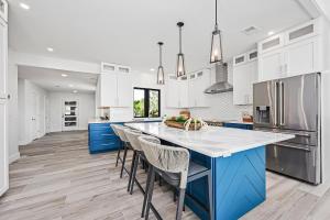 a kitchen with blue and white cabinets and a large island at Sea La Vi in Navarre