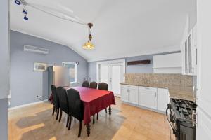 a kitchen with a table with a red table cloth at Charming Atlanta Home in Atlanta +6 photos