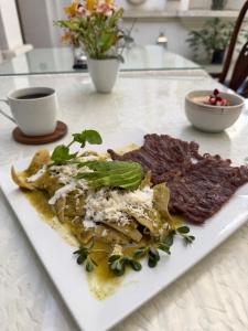 a white plate of food on a table at Ébano Hotel Boutique in Oaxaca City