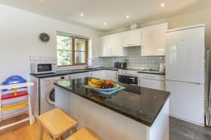 a kitchen with a bowl of fruit on a counter at 3 Bed in Shebbear oc-l32582 in Shebbear