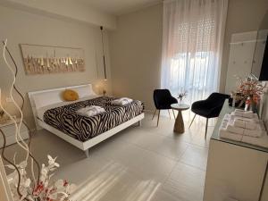 a zebra print bed in a room with a table and chairs at Salotto Santa Franca in Piacenza