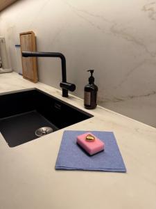 a soap sitting on a blue towel next to a sink at Finnvika Panorama Corner in Vestvågøya