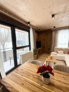 een woonkamer met een houten tafel en een bank bij Apartmán Forest, Tatranská Štrba in Tatranska Strba