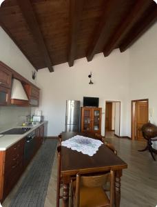 a kitchen with a wooden table and a kitchen with a refrigerator at B&B Maria appartamento con stanza matrimoniale e soggiorno vicino alla fiera 2 in Rimini