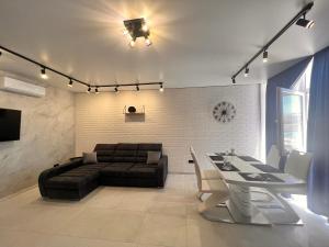 a living room with a couch and a table at Golden Bugas Sea View Золотий бугаз in Karolino-Buhaz