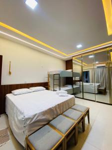 a bedroom with a large bed and a large mirror at Flat 02 Residencial ibiapaba in Camocim