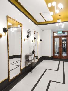 a dressing room with a mirror and a sink at Cozy Duo Loft Studio in Tartu