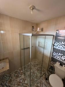 a bathroom with a shower with a toilet and a sink at Hospedaria de Maria in Tiradentes