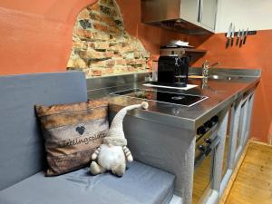 a stuffed animal sitting on a bench in a kitchen at Rost Apartments - Laufen in Laufen
