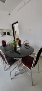 a dining room table and chairs in a room at Nima Residency in Kollam