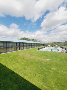 a large grassy field in front of a building at Heritage Inn Cartersville in Cartersville