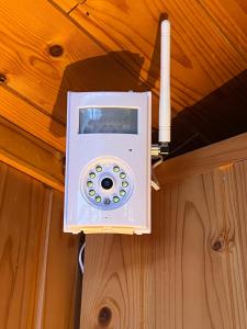 a white phone hanging from a ceiling at A cosy 2 bedroom cabin with an amazing view in Borgarnes +13 photos