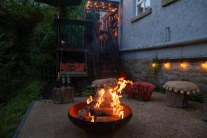 a fire pit in a yard next to a building at River Cottage at Old Post Office in Bardon Mill