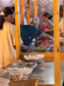 a group of people in a buffet line with food at RUM ARIZONA lUXURY CAMP in Wadi Rum