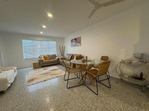 a living room with a table and a couch at Large Earthy toned Apartment in Ross River