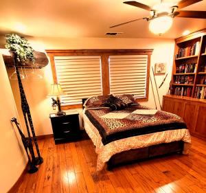 a bedroom with a bed and a book shelf at Kings River Reflections in Sanger
