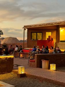 a group of people sitting outside of a building at Mira Bubble Luxury Camp in Wadi Rum