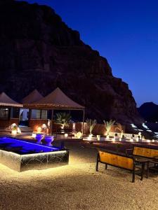 a resort with a swimming pool at night at Mira Bubble Luxury Camp in Wadi Rum +67 photos