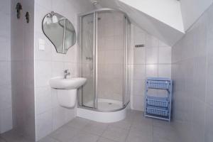 a white bathroom with a sink and a shower at Pokoje U SABI in Wisła +21 photos