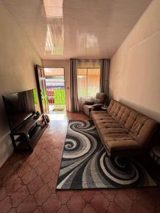 a living room with a couch and a television at Casa Girasol PZ in San Isidro