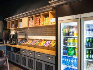 a refrigerator filled with lots of drinks in a restaurant at ibis Amsterdam Centre in Amsterdam