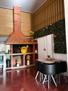 a kitchen with a table and a brick fireplace at Casa Girasol PZ in San Isidro