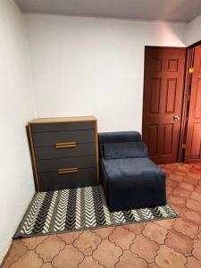 a room with a bed and a dresser and a door at Casa Girasol PZ in San Isidro