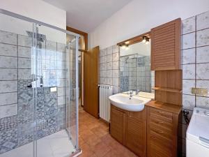 a bathroom with a sink and a shower at BBkey Borgo Living Sutrio in Sùtrio