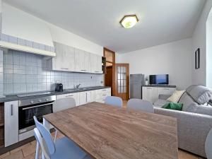 a kitchen with a table and chairs and a couch at BBkey Borgo Living Sutrio in Sùtrio +10 photos