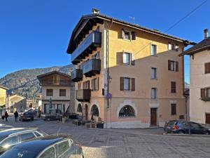 a building with balconies on the side of a street at BBkey Borgo Living Sutrio in Sùtrio
