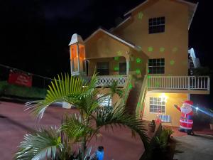 a santa claus standing outside of a house at night at Caribbean Dream Vacation Property CD6 in Rodney Bay Village