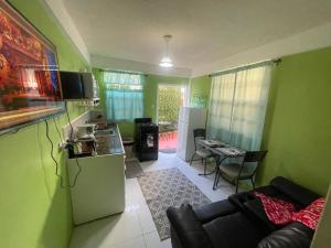 a kitchen and a living room with green walls at Caribbean Dream Vacation Property CD6 in Rodney Bay Village