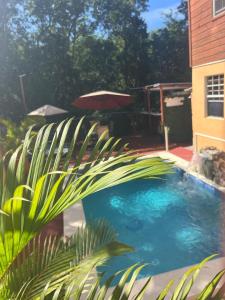 a swimming pool in front of a house at Caribbean Dream Vacation Property CD6 in Rodney Bay Village