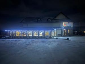 a building with christmas lights on it at night at Hanul Mariei in Livezile