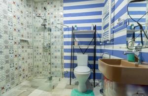 niebiesko-biała łazienka z toaletą i umywalką w obiekcie Residence Kavkasioni w mieście Telawi