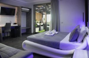 a bedroom with a large bed with purple pillows at Residence Villa Rosa dei Venti in Cinisi +57 photos