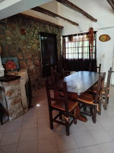 a dining room with a wooden table and chairs at Santa Mónica in Villa Giardino