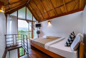 a bedroom with a bed and a balcony at Ollie resort in Ella