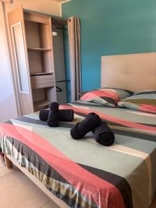 two beds sitting next to each other in a bedroom at Vanille-colibris Le Domaine Mannou in Sainte-Rose +16 photos