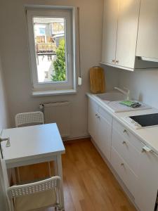 a kitchen with a white counter and a window at Marienkirche 2 - ABC336 in Wismar