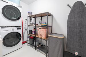 a laundry room with a washing machine and a shelf at Ferienhaus Daheim in Sankt Peter