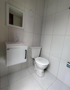 a white bathroom with a toilet and a sink at Casa Vivah in Lençóis +15 photos