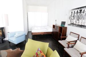 a living room with a couch and two chairs at Zuhause am Boulevard - ABC40 in Wismar